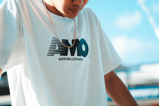 man in white crew neck t-shirt wearing silver necklace