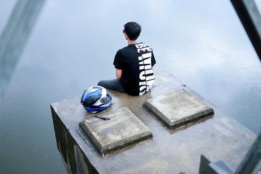 a man sitting on a stone bench