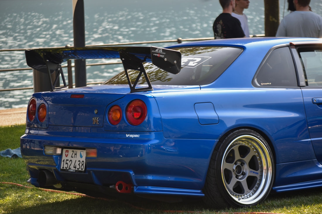 a blue car parked on top of a lush green field