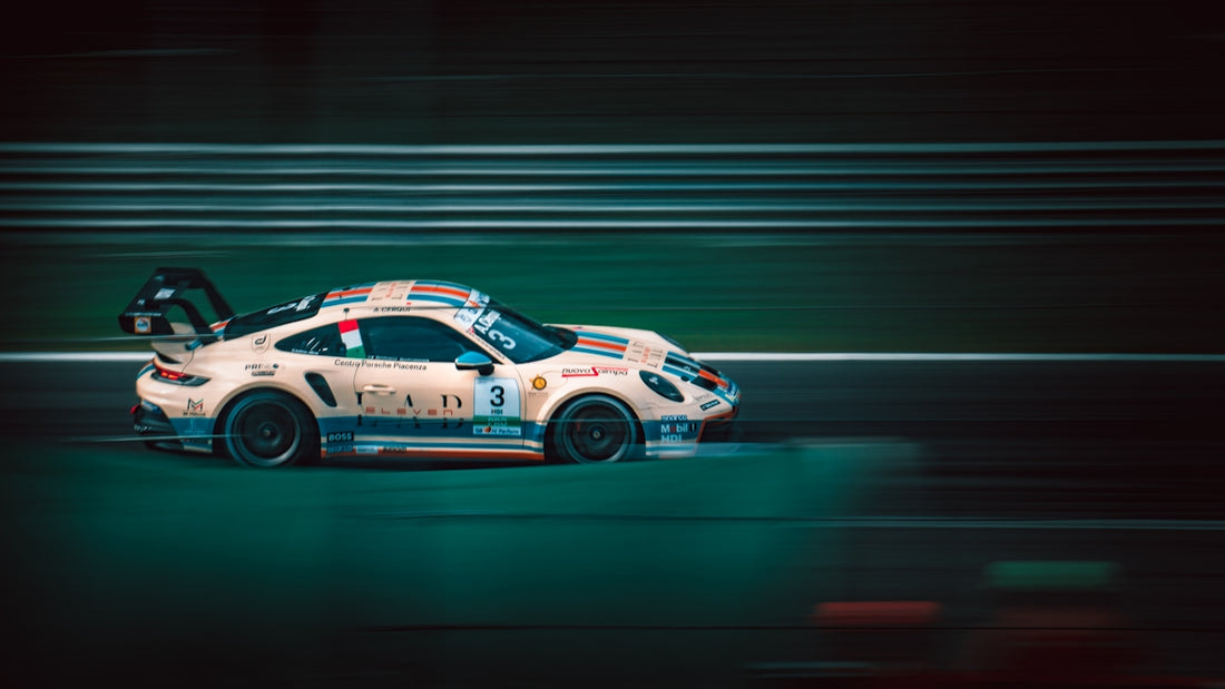 a white car driving down a race track