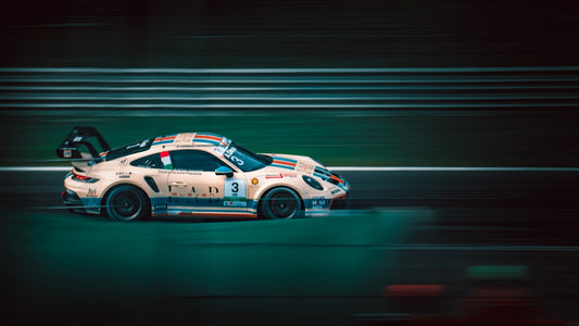 a white car driving down a race track