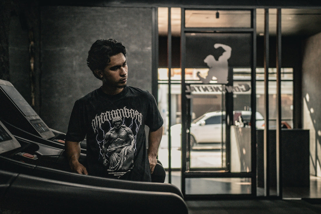A man standing next to a car in a garage
