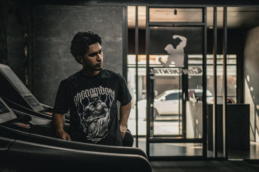 A man standing next to a car in a garage